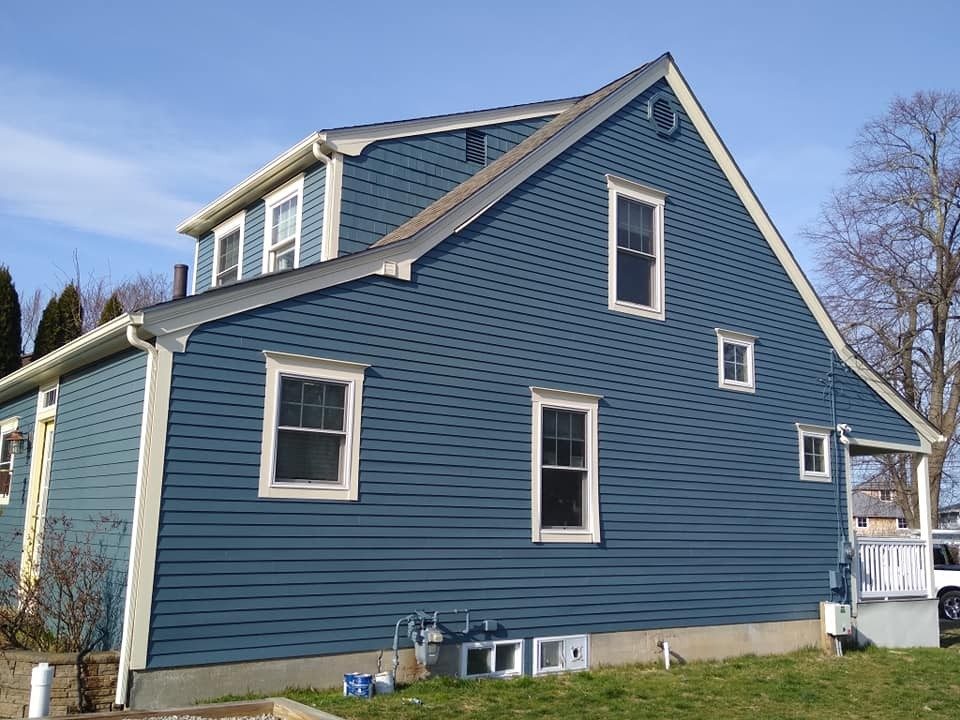 Blue exterior repaint with white trim on a Rhode Island home by Genesis Painting