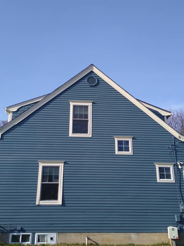 Blue clapboard home repainted by Genesis Painting in Rhode Island