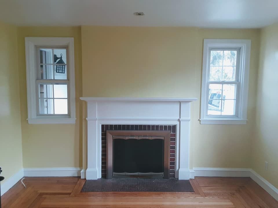 Living room with fireplace repainted by Genesis Painting
