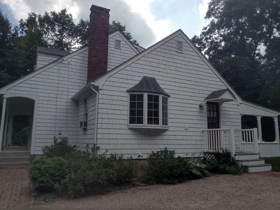 Older cape-style home exterior painted by Genesis Painting