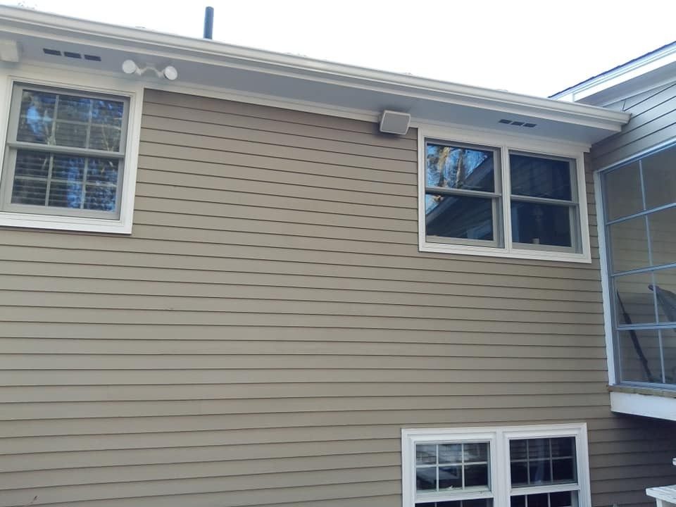 Exterior siding and window trim painted by Genesis Painting